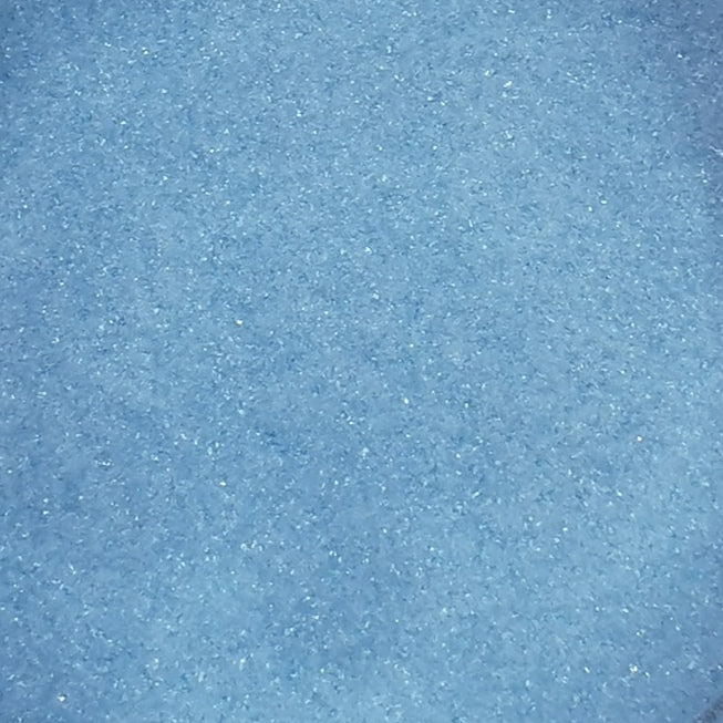 Close-up view of a blue colored frit, typically used in glass crafting.
