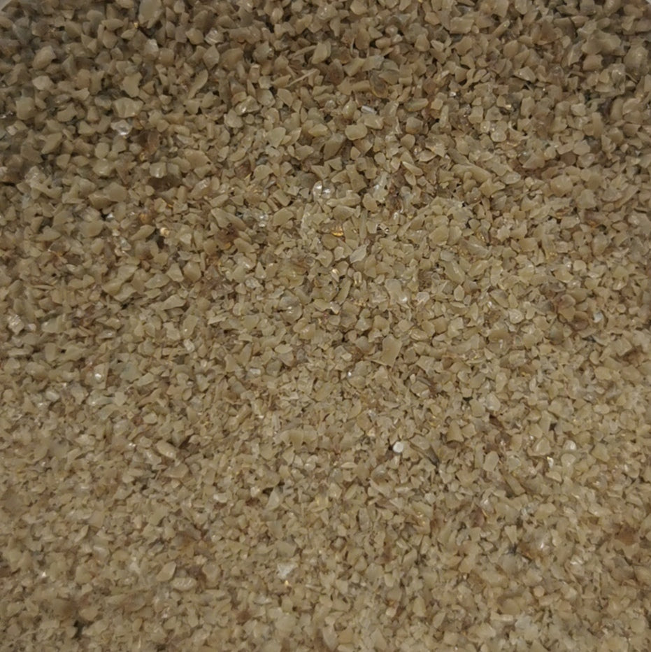 Close-up view of an 8oz bottle of OGT Chocolate Opal System 96 frit, displaying a beige-colored textured surface.