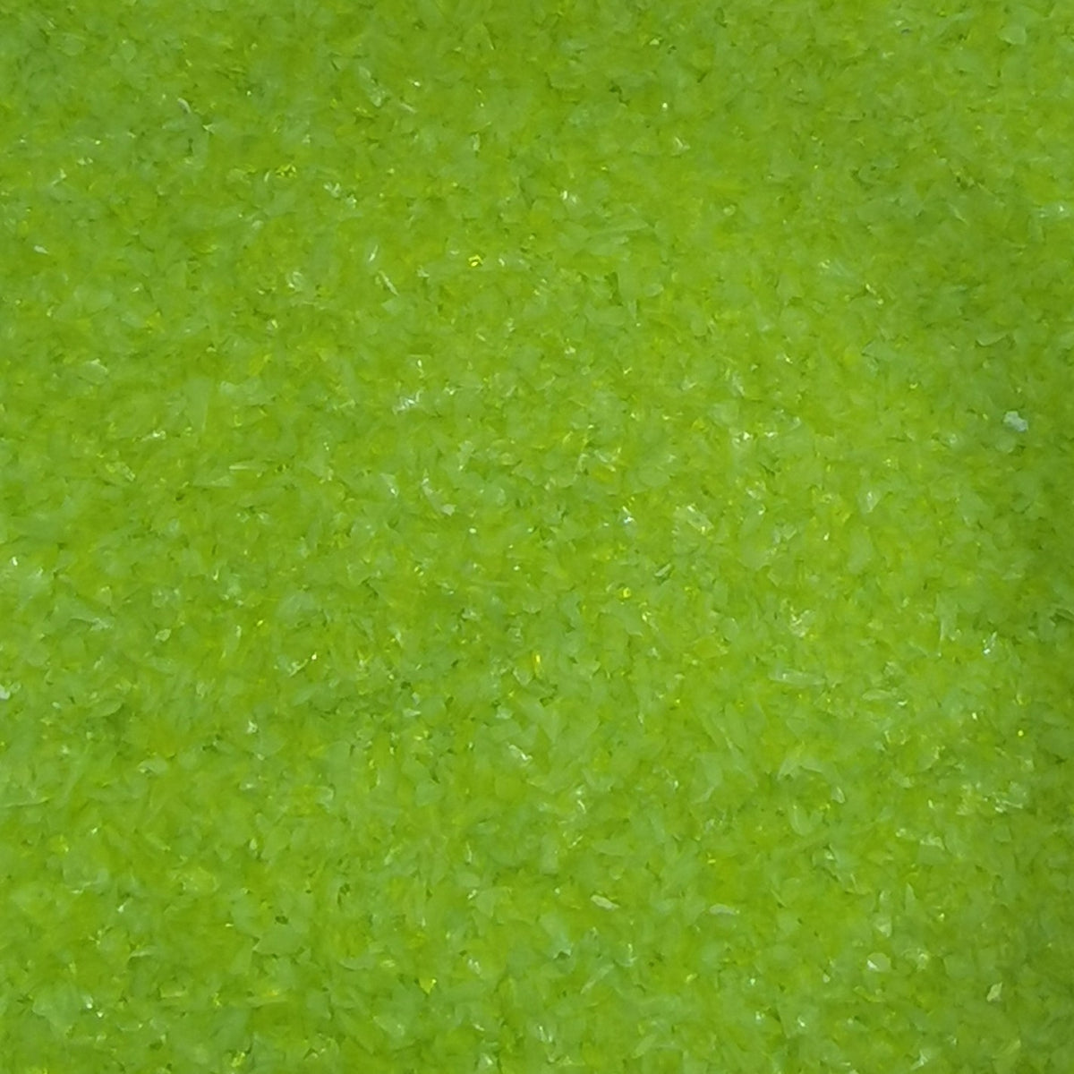 Close-up view of a bottle of OGT Lemongrass Opal 2262 System 96 8oz Frit, showing the textured surface of the frit.