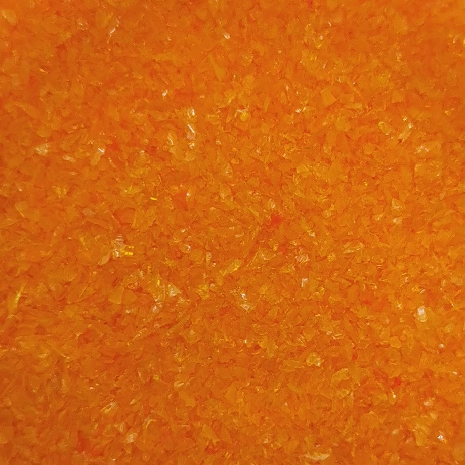 Close-up of an orange opalescent glass frit texture.