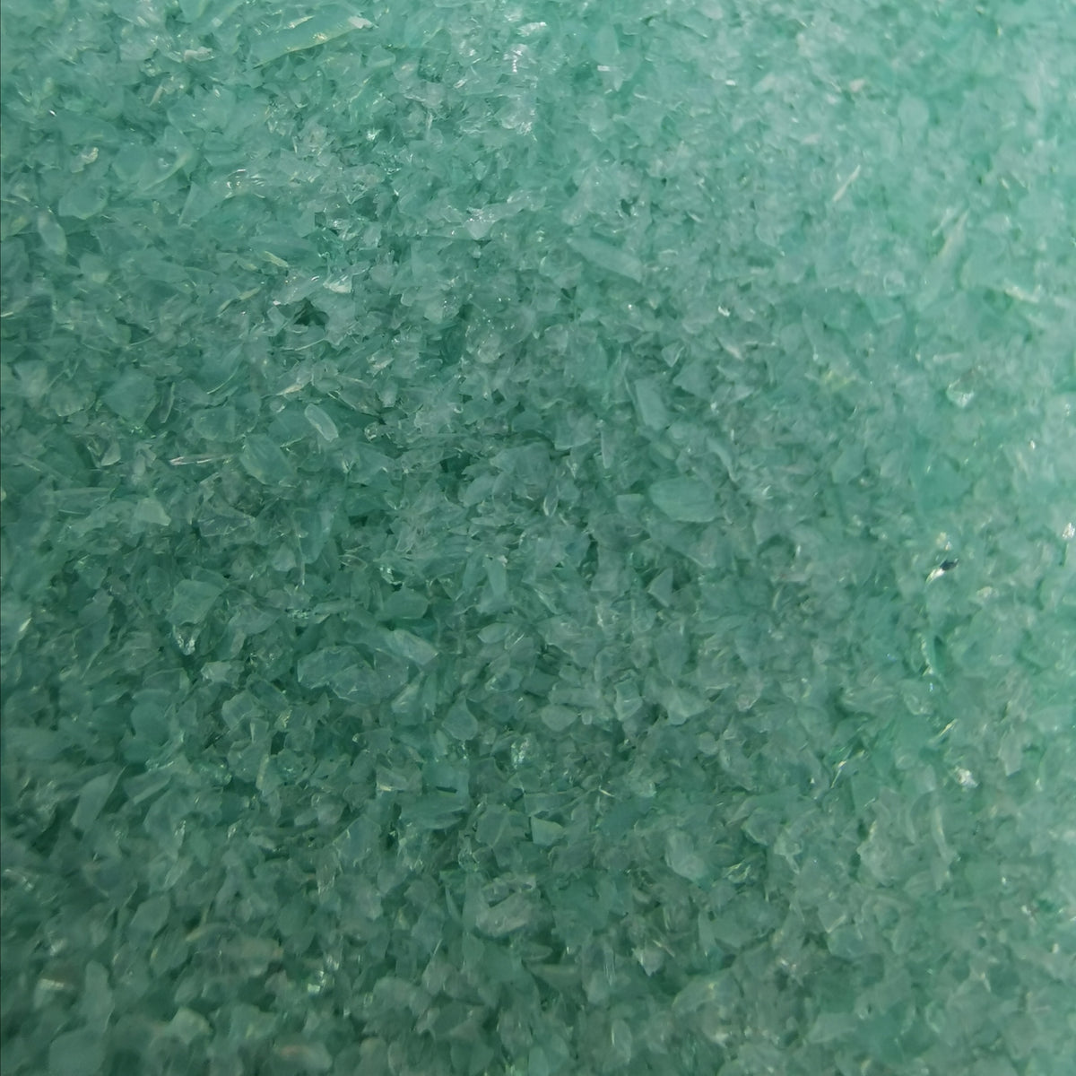 Close-up view of a textured green surface with a blurred edge.