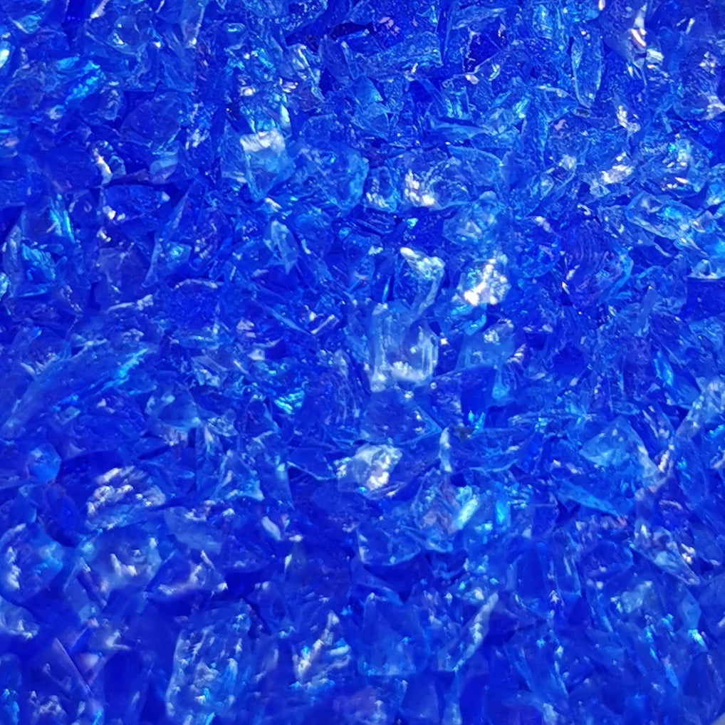 Close-up of light blue transparent frit, showing granular texture.