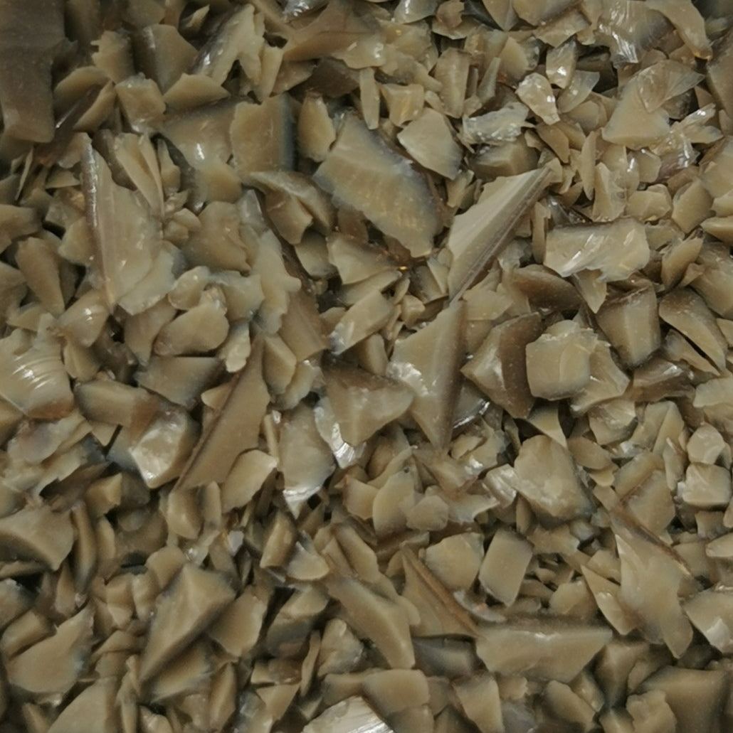 Close-up view of an 8oz bottle of OGT Chocolate Opal System 96 frit, displaying a beige-colored textured surface.