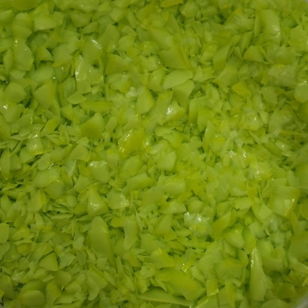 Close-up view of a bottle of OGT Lemongrass Opal 2262 System 96 8oz Frit, showing the textured surface of the frit.