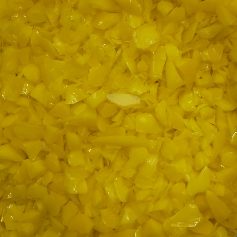 Close-up of yellow opalescent glass frit.