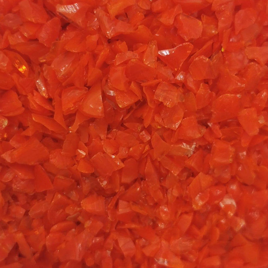 Close-up of an orange opalescent glass frit texture.