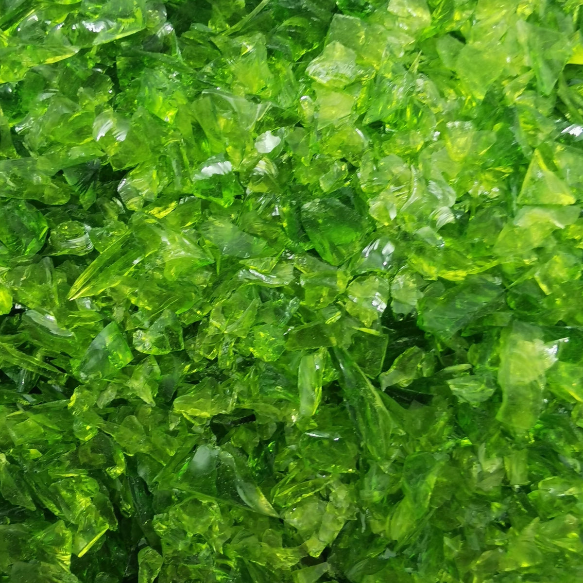 Close-up of moss green transparent frit, showing texture and color.