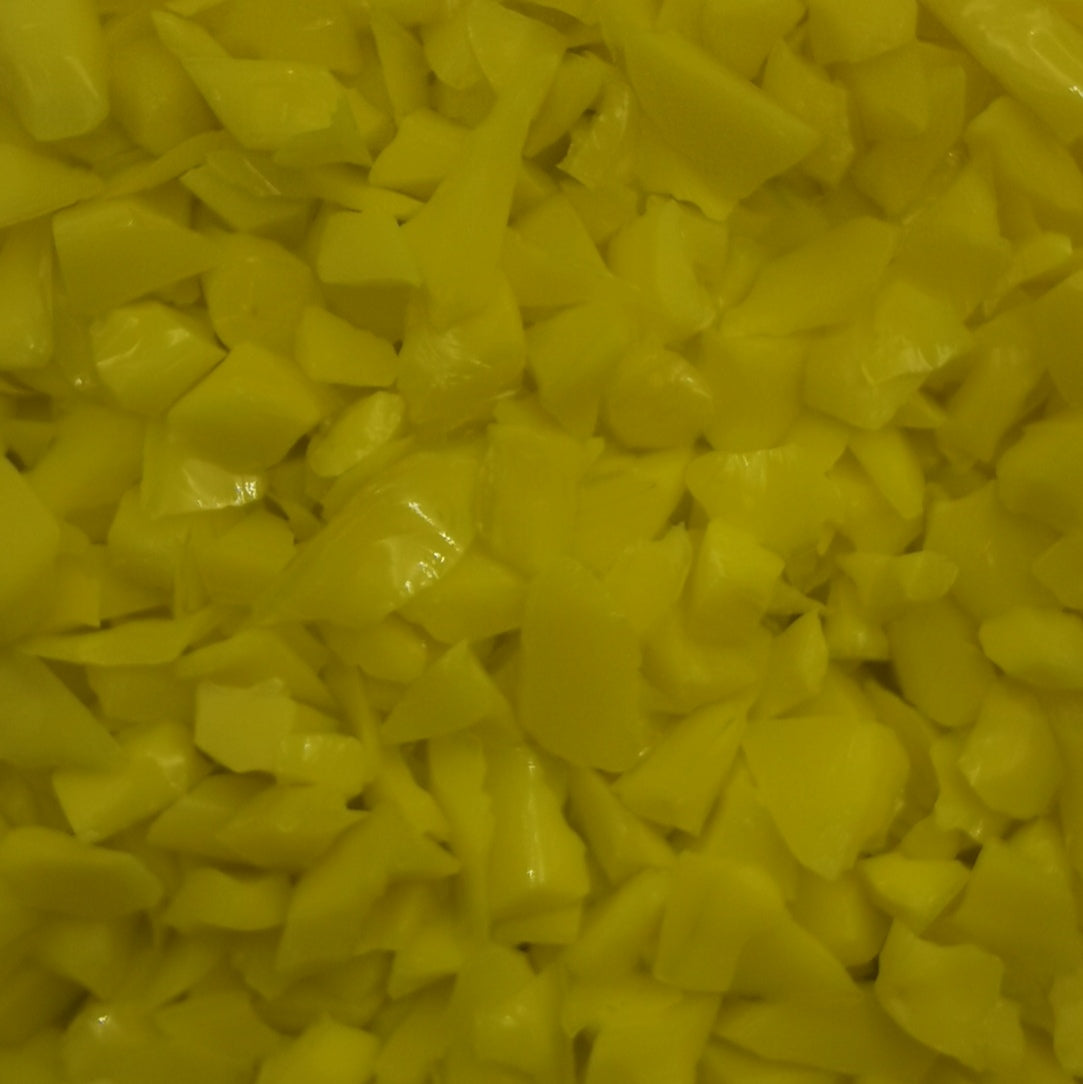 A close-up image of yellow opal frit, showing the texture and color of the glass material.