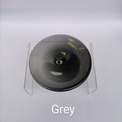 A grey hand blown glass rondel for stained glass work.