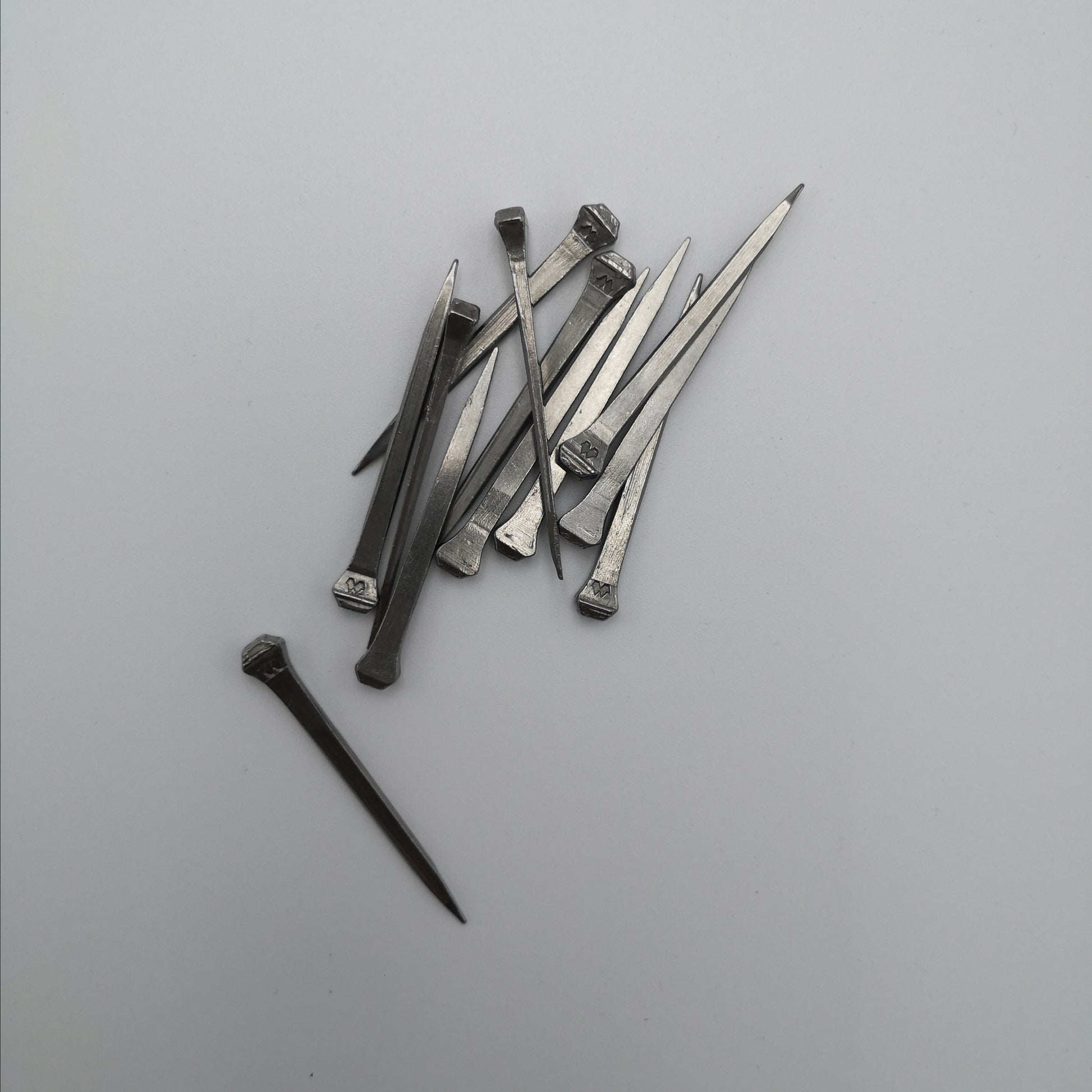 A pile of horseshoe nails used for stained glass work.