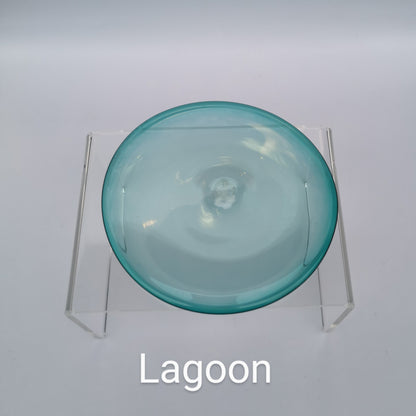 A teal hand blown glass rondel for stained glass work.