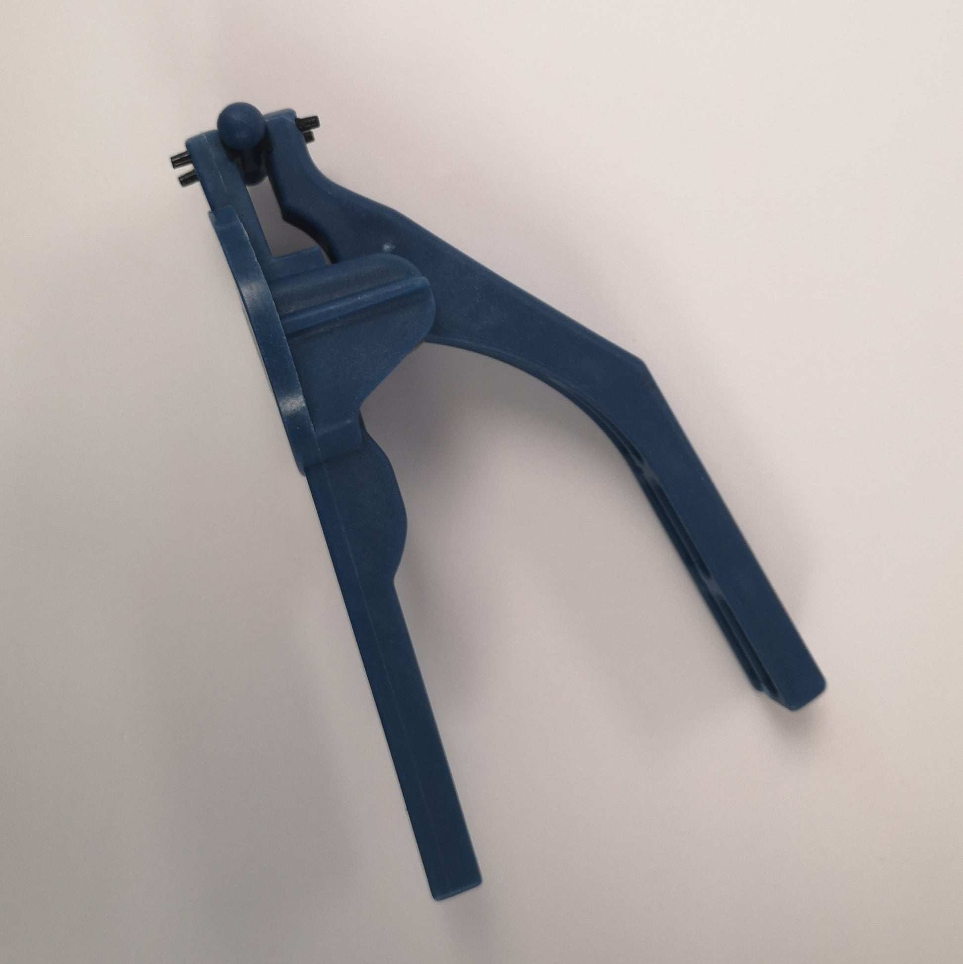 A tool for holding glass pieces when grinding for stained glass.