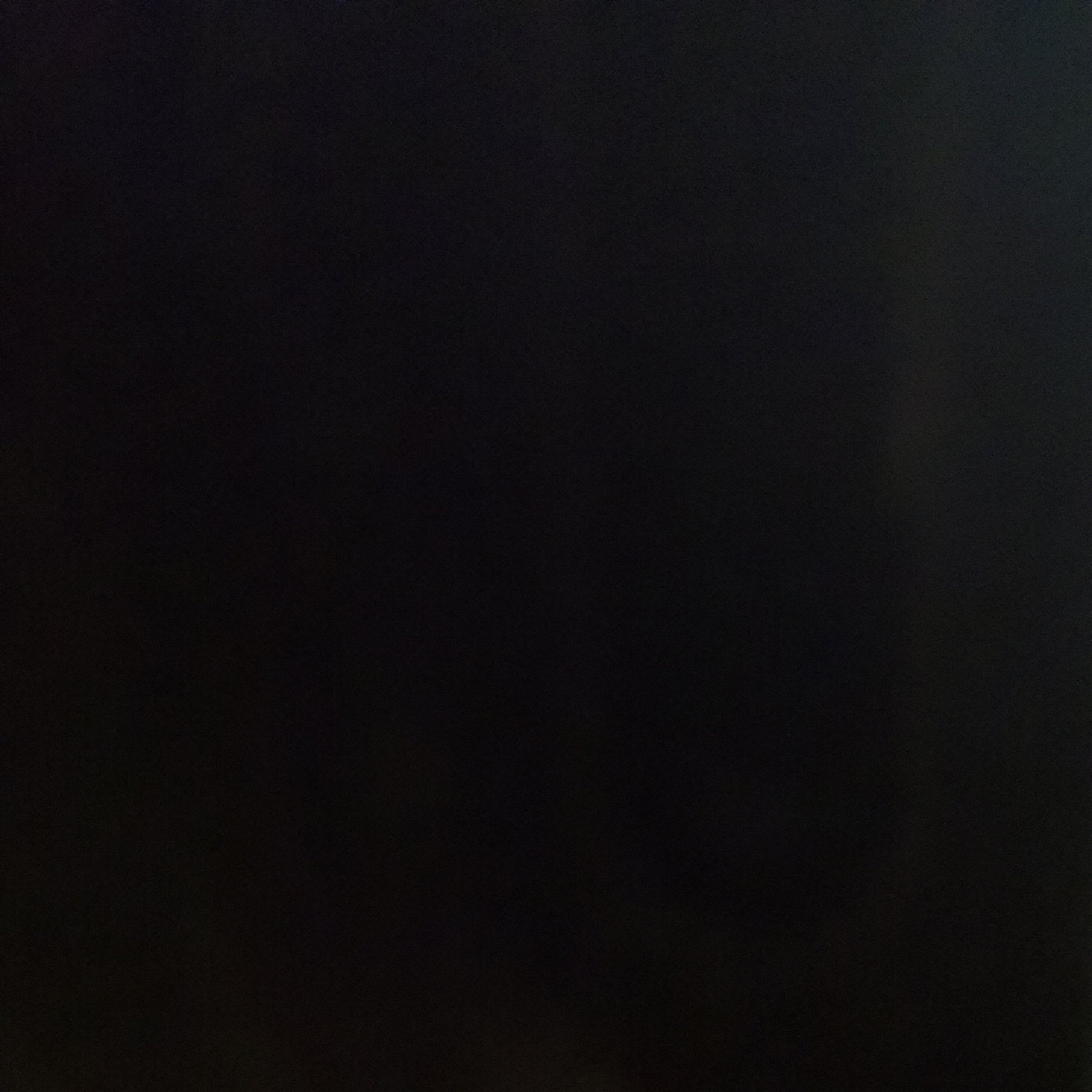 A sheet of black opal smooth fusible glass.