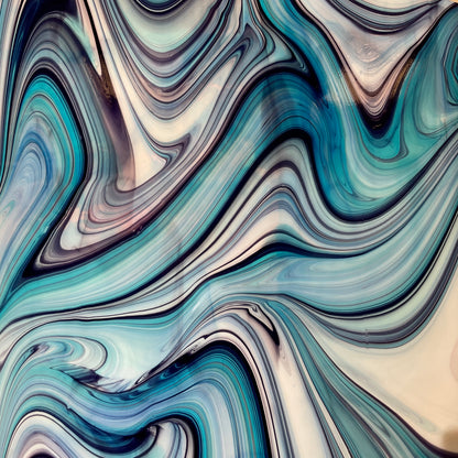 A sheet of fusing glass with an abstract blackberry cream opal pattern, featuring swirls of blue and cream colors.