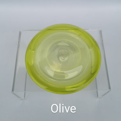An olive green hand blown glass rondel for stained glass work.