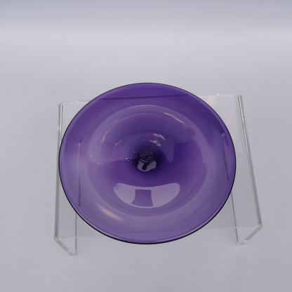 A purple hand blown glass rondel for stained glass work.
