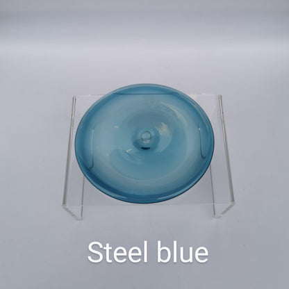 A steel blue hand blown glass rondel for stained glass work.