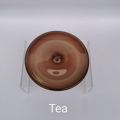 A brown tea-coloured hand blown glass rondel for stained glass work.