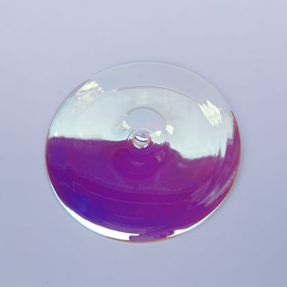 A trichroic glass rondel for stained glass work.